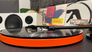 Pick-up JBL Spinner BT din unghi lateral redând un disc