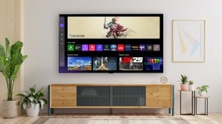 Televizorul LG G5 montat pe perete deasupra unei console din lemn, cu meniul de jocuri pe ecran.