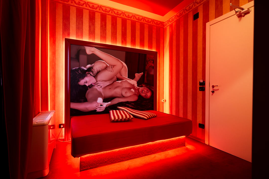 Bed with erotic artwork in a standard room