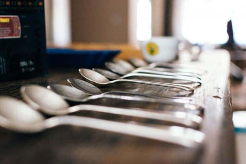 a row of spoons on a table