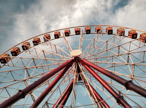 a ferris wheel with blue sky and clouds