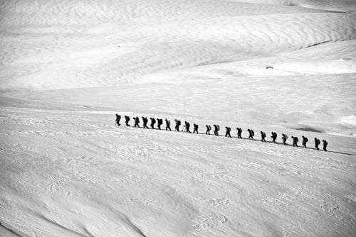 a group of people walking on snow