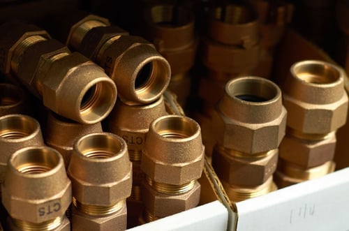 a group of gold pipes in a box