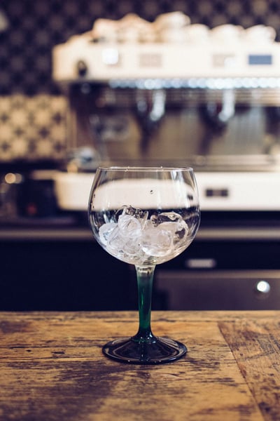 a glass with ice on a table