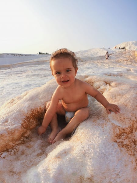 a baby sitting in a pool of foam