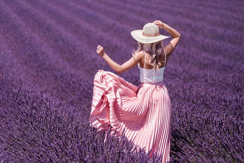 a woman in a hat in a lavender field