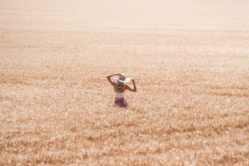 a woman in a field of wheat