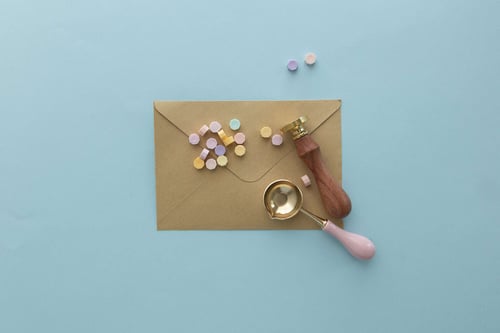 a envelope with a stamp and a spoon