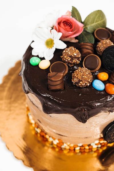 a cake with chocolate frosting and flowers