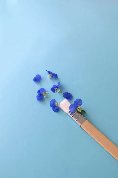 a paint brush with blue flowers