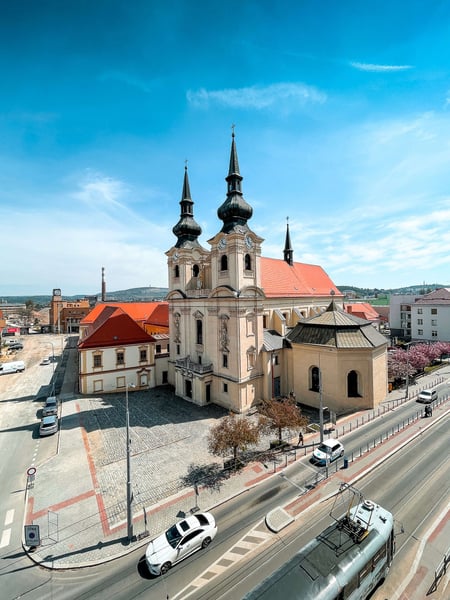 a large building with towers and a street in the background