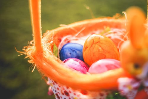 a basket with colorful eggs