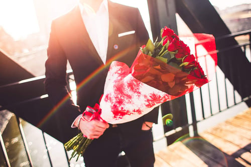 a person holding a bouquet of roses