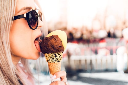 a woman eating an ice cream cone