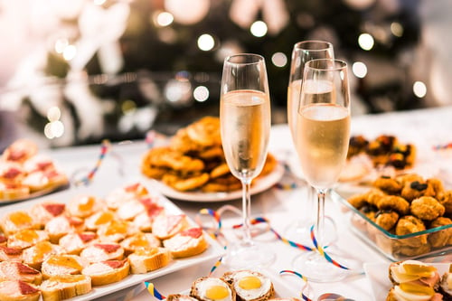 a table with food and champagne glasses