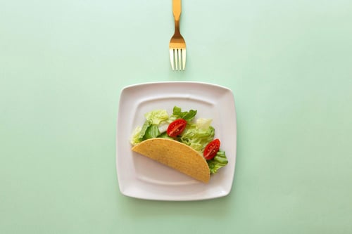 a taco on a plate with a fork
