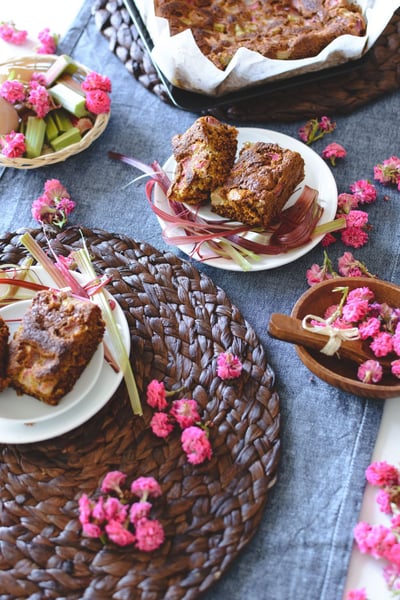 cucumber and rhubarb baked bread on a table with flowers vertical