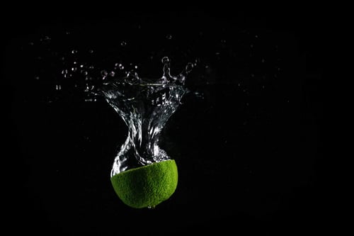 a lime falling into water