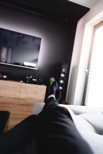 a person's feet in a room with a tv