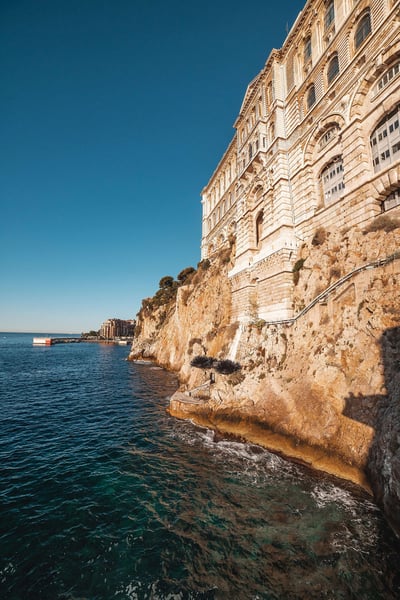 a building on a cliff by the water