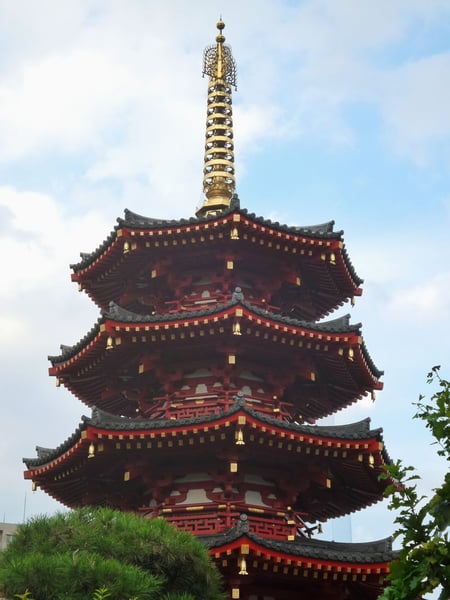 a pagoda with a gold cross on top