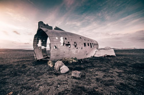 a broken airplane in a desert