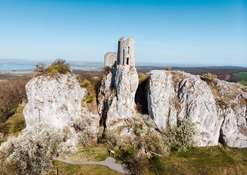 a stone castle on top of a rocky hill