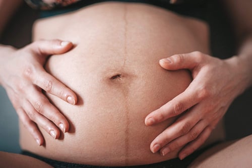 a close up of a pregnant woman's belly