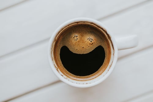 a coffee cup with a smiley face in it
