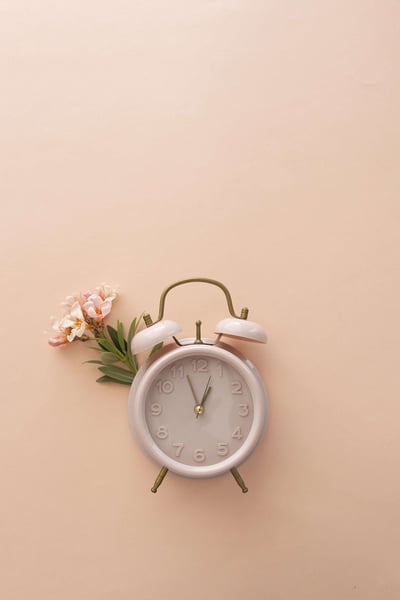 a clock with a flower on it