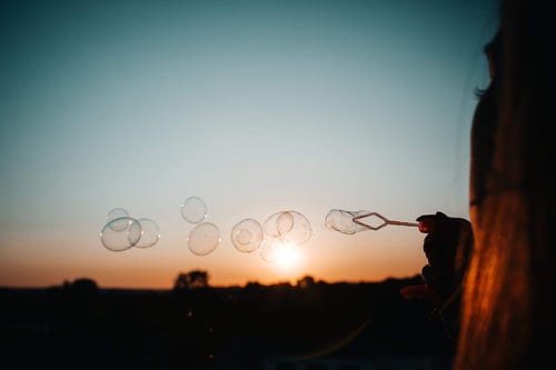a person blowing bubbles in the air