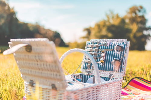 a picnic basket on a blanket