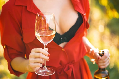 a woman holding a glass of wine