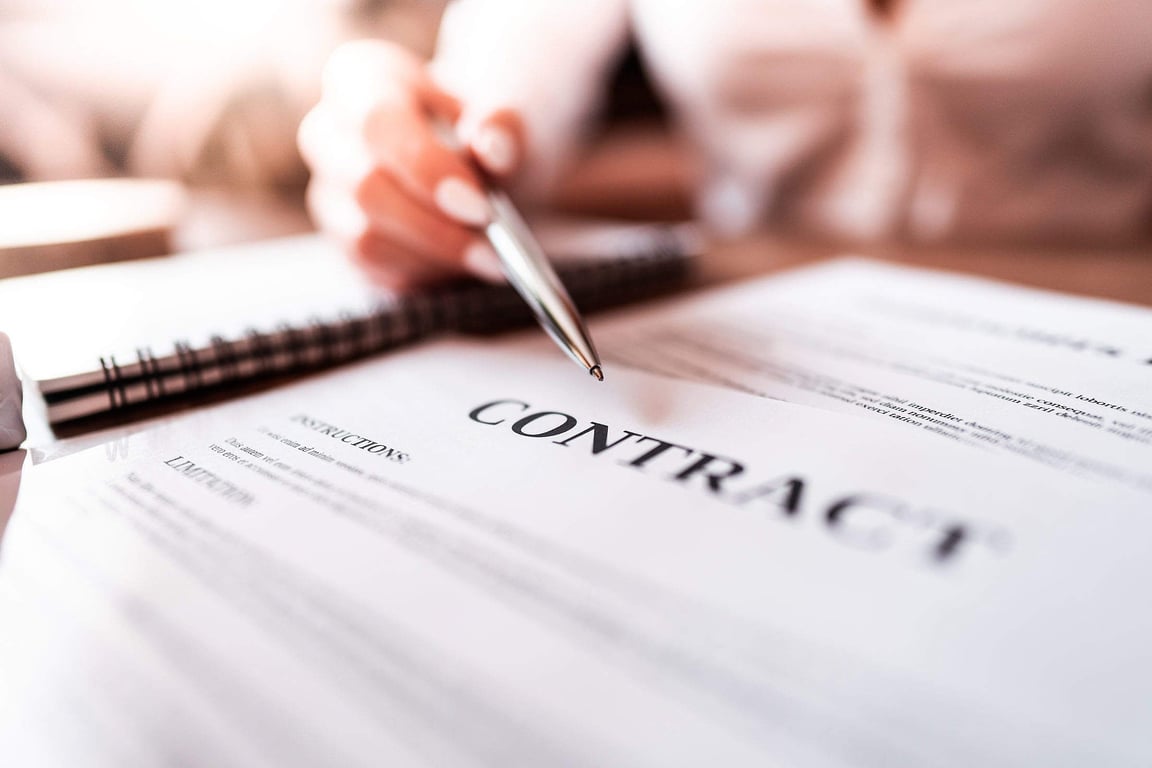 Woman Pointing At Business Contract With Silver Pen