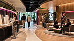 Visitors exploring a warm, human-centered custom commercial interior