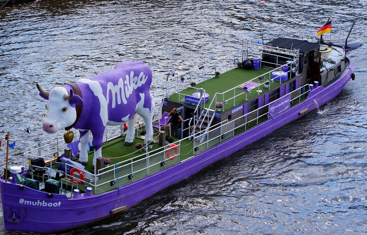 Experiential advertising in out-of-home (OOH) advertising shown by chocolate branded mascot and wrapped boat