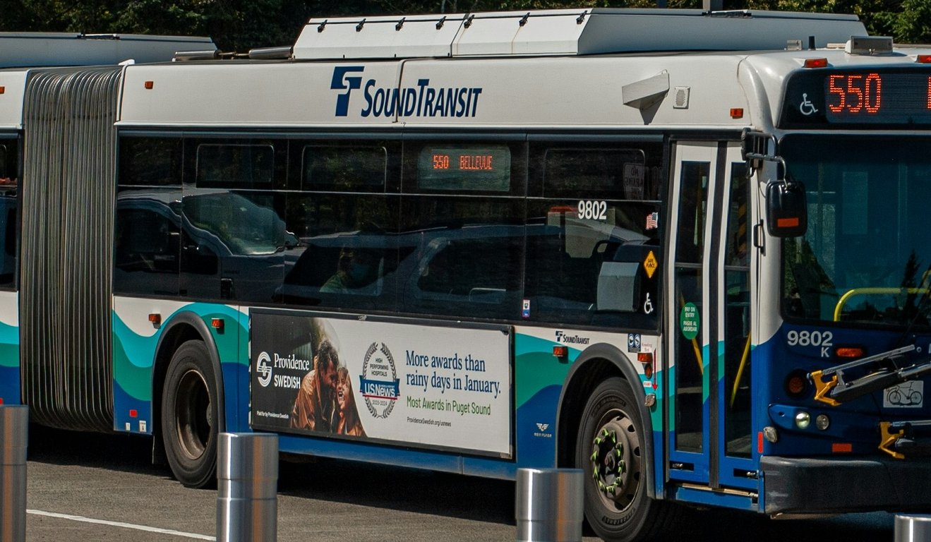 Queen bus panel in out-of-home (OOH) advertising on side of Sound Transit bus