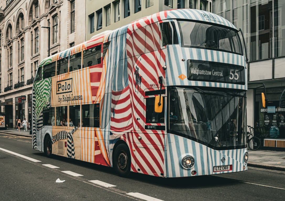 Full bus wrap in out-of-home (OOH) advertising shown by double decker bus wrapped in Polo ad