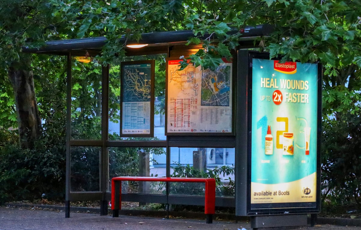 Bus shelter advertising on side of bus stop waiting area