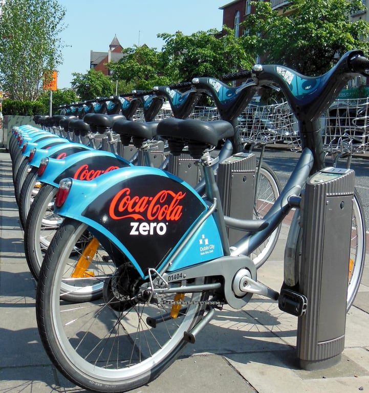 Bike-share advertising in out-of-home (OOH) advertising shown by Coca Cola branded urban bikes