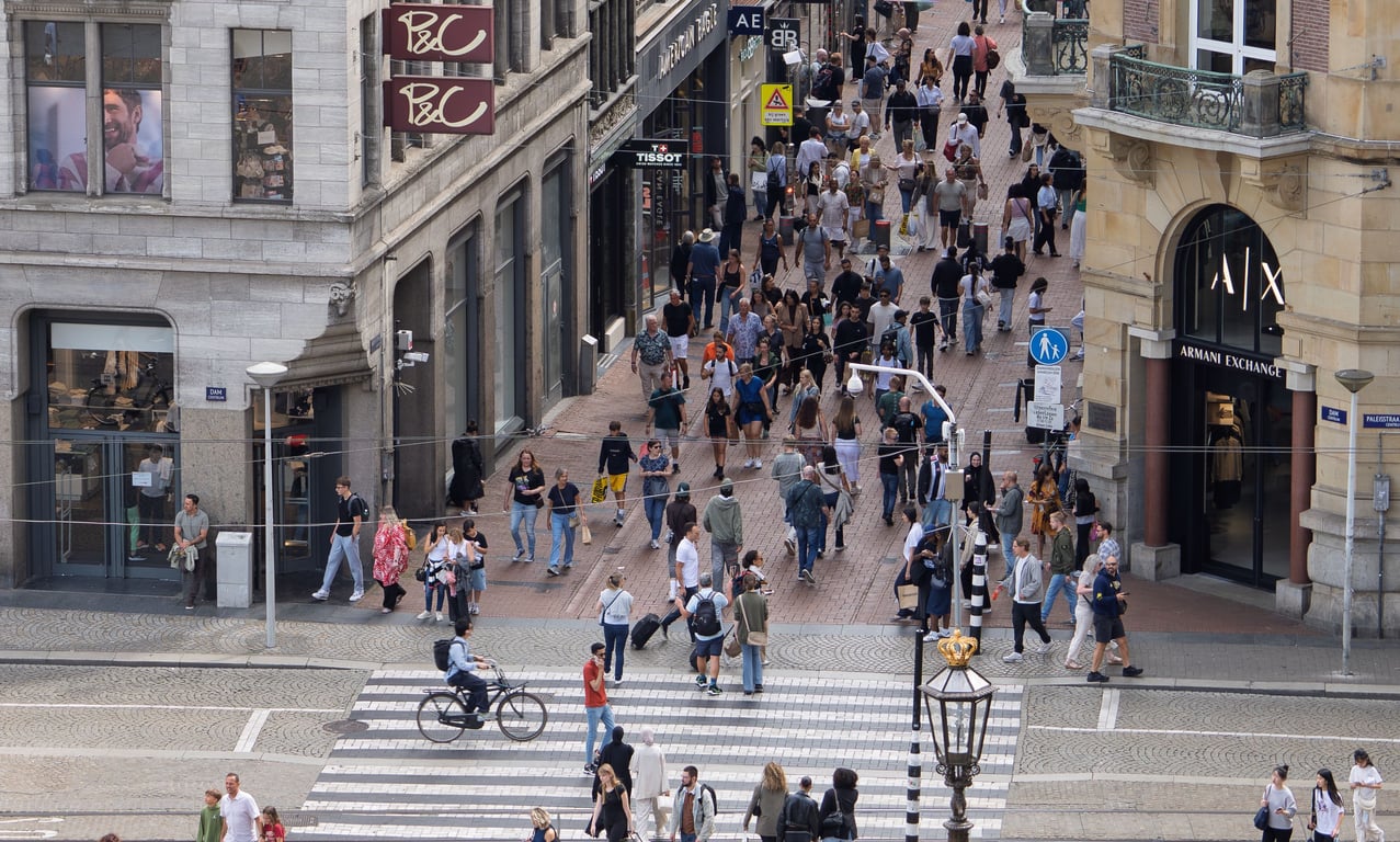 Foot traffic in out-of-home (OOH) advertising shown by people walking down corridor and streets
