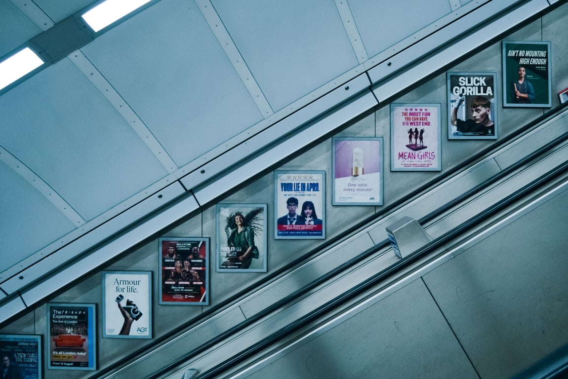 Escalator advertising in out-of-home (OOH) advertising with signs alongside stairs
