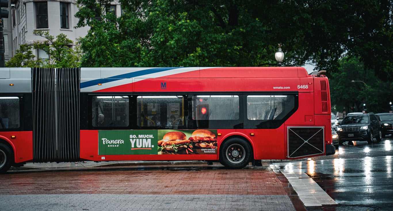 King bus panel in out-of-home (OOH) advertising shown by large ad on side of city bus