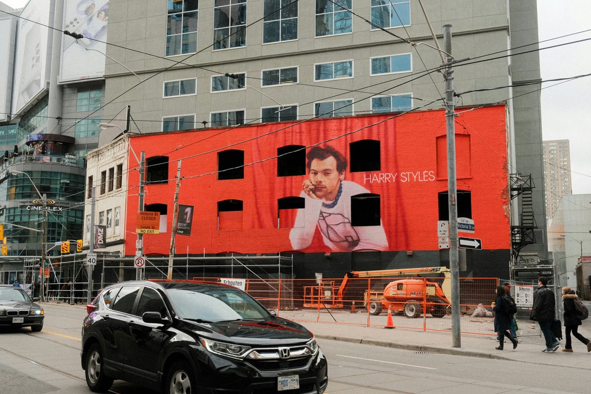 Building wrap in out-of-home (OOH) advertising depicting pop star on side of wall