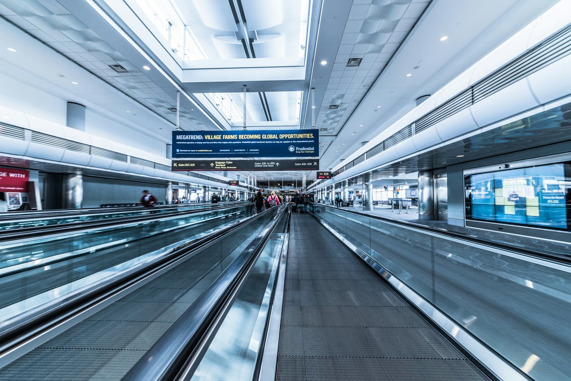 Moving walkway advertising in out-of-home (OOH) advertising shown by banner over airport walkway