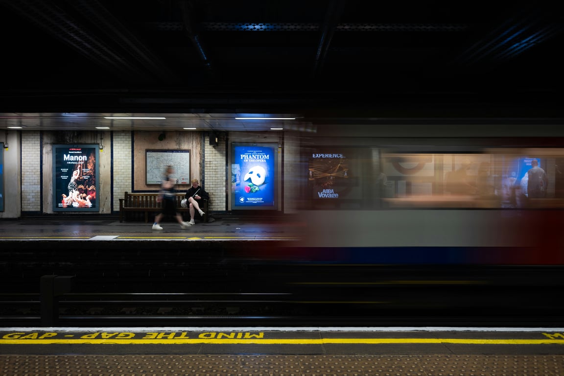 Rail advertising in out-of-home (OOH) advertising shown by outdoor train platform with digital signs