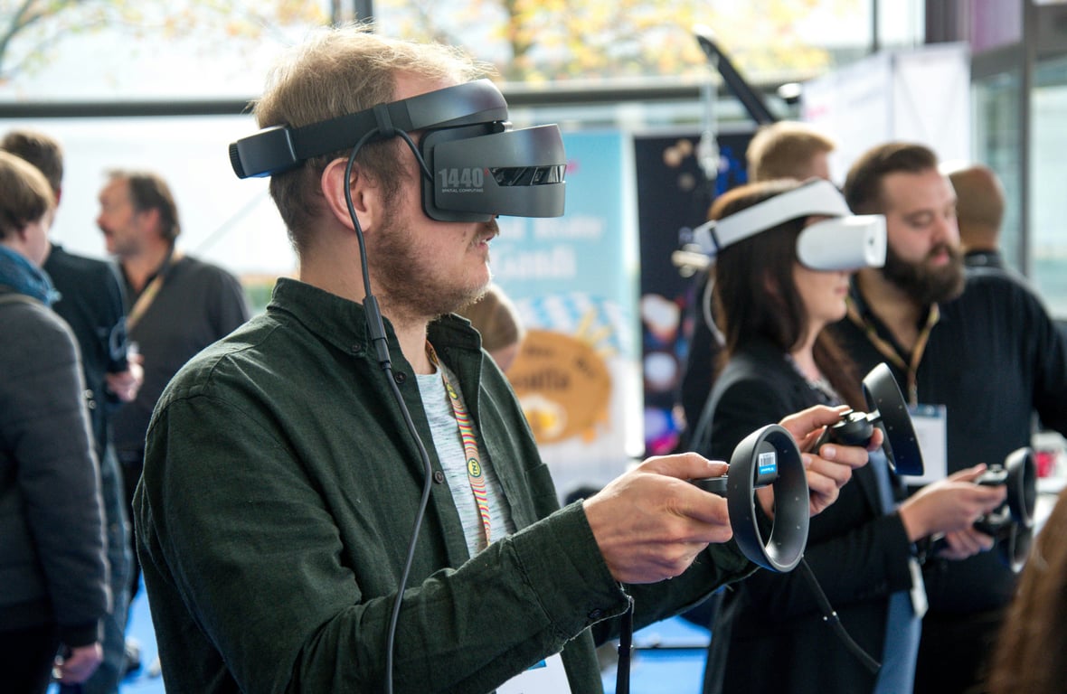 Augmented reality (AR) in out-of-home (OOH) advertising depicted by man with AR headset and remotes
