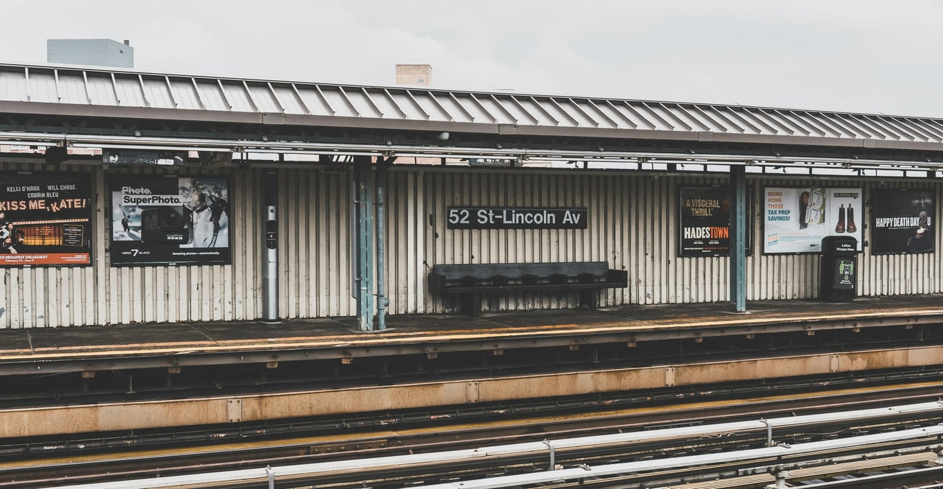Rail station advertising in out-of-home (OOH) advertising shown at outdoor train platform with poster ads