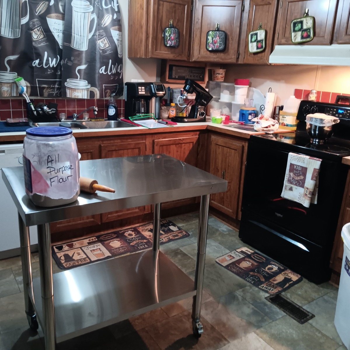 My new stainless steel work table. It was a much needed addition to our kitchen. It provides a work surface that's better than our counter tops. This is the most used spot in the kitchen other than the stove. 