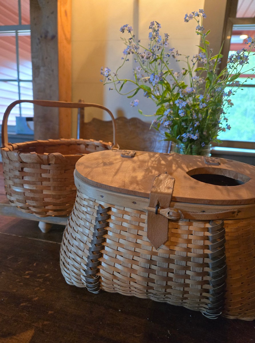 homemade baskets sitting on a wood table next to a jar of forget me nots